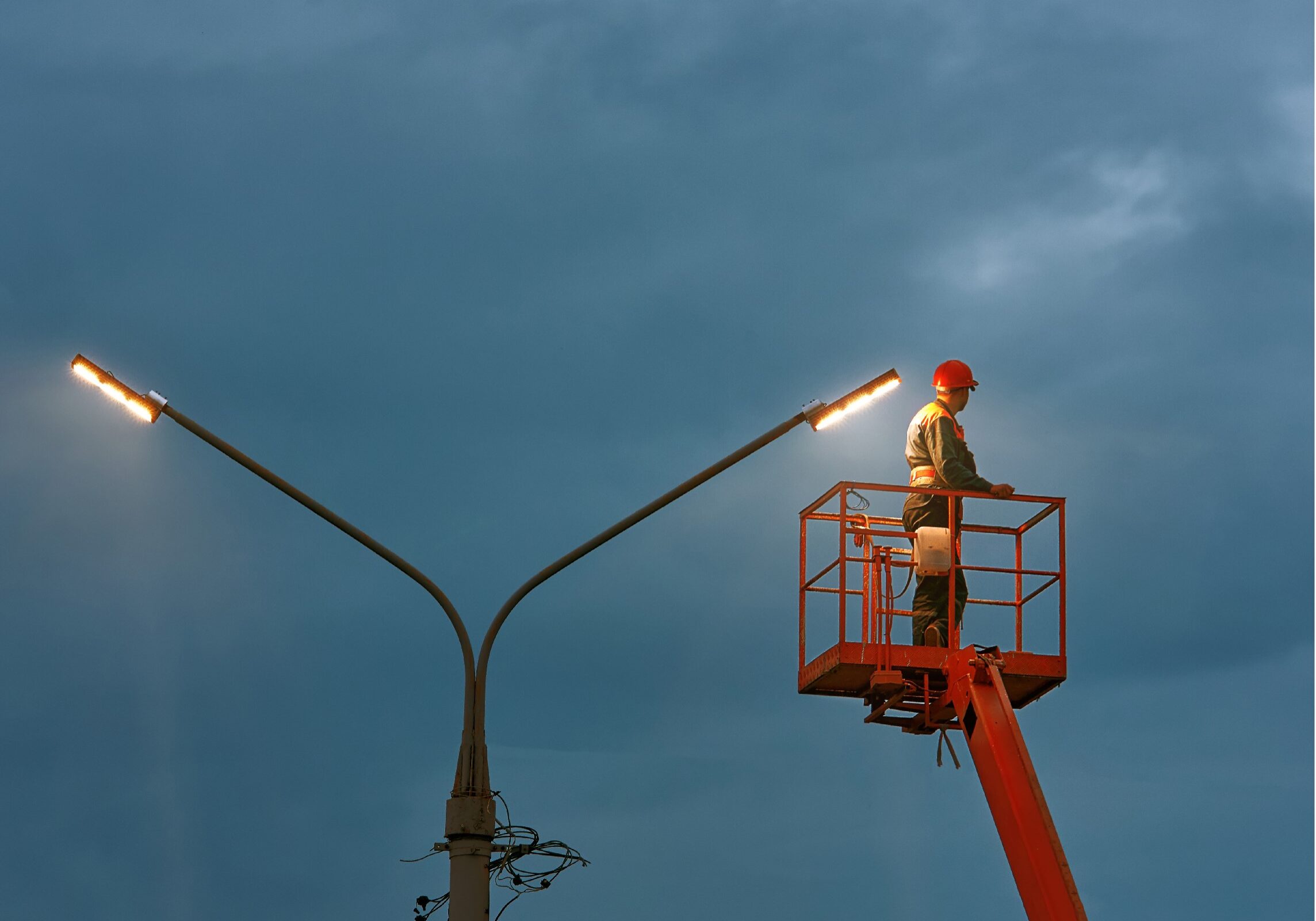 Man in Bucket Truck at Dusk Resized